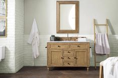 a bathroom with a sink, mirror and towel rack in it's center area