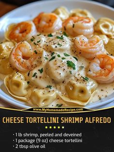 a white plate topped with pasta and shrimp