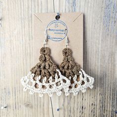 crochet earrings with tassels on wooden table next to card and tag