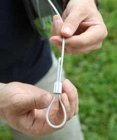 a person holding an object in their hands with one end twisted up and the other end unplugged