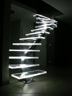 a staircase made out of books in the dark with light coming from it's sides