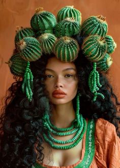 a woman with long black hair and green cactus decorations on her head, wearing an orange top