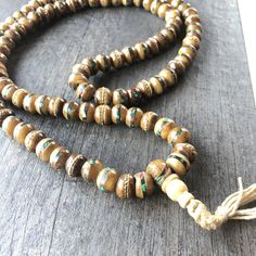 Unique and powerful Nepali Yak Bone Mala. Each bead has bras and small stone details. A unique unisex piece that will be perfect for your day by day outfits. The Mala is 40.6cm- 16 inch long A most have addition to your jewelry collection. Enjoy Con salud Tibetan Ring, Tibetan Mala, Buddhist Necklace, Wish Necklace, Tibetan Necklace, Cool Necklace, Buddhist Mala, Wiccan Necklace, Natural Opal Ring