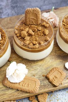 three desserts are arranged on a wooden board