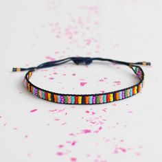 This delicate beaded bracelet is a mini rainbow. Adjustable cord closure from 5-9". Made by artisans in Guatemala Beaded Braclets, Beaded Dog Collar, Tom Y Jerry, Pride Jewellery, Pride Bracelet, Lovers Bracelet, Loom Bracelet Patterns, Bracelets Handmade Diy, Miyuki Bracelet