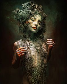 a woman is covered in wire and has her hands on her chest