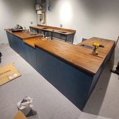 an empty room with several work benches and tools on the counter top in front of it