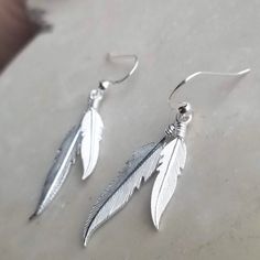 925 Sterling Silver Feather Drop Earrings Simple earrings to add to any outfit for any time of the day or week. >Metal: 925 Sterling Silver >Width:7 mm. >Height:45 mm >Nickel Free >No Allergic reaction >30 days return policy ++Items come in a gift box ready to be gifted Please contact me if you have any questions about the jewelry you are interested in buying. My Shop: https://www.etsy.com/shop/banujewelryusa Follow BANU Jewelry on Facebook, Instagram and other social media sit Elegant Silver Feather Earrings, Elegant Adjustable Feather Earrings, Sterling Silver Feather Earrings Gift, Adjustable Silver Earrings With Feathers, Adjustable Silver Feather Earrings, Elegant Feather Earrings For Gift, Elegant Feather Earrings, Elegant Sterling Silver Feather Jewelry, Drop Earrings Simple