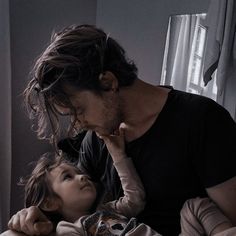 a man and child laying in bed together