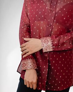 DESCRIPTION: Discover the epitome of luxury with our exquisite "Afreen Gold Textured Dots Shirt" in Maroon for women by SaaRii, a masterpiece designed to highlight the artistry of Benarasi Saree fabric. Indulge in the heritage of Benarasi sarees renowned for their opulent gold or silver zari brocade work, adorned with splendid motifs inspired by the grandeur of Mughal art and architecture. Designed thoughtfully, this shirt boasts a captivating brocade pattern on the cuffs, back yoke, and inside collar stand. The deliberate arrangement of gold "zari" dots, ingeniously placed inside out, creates a mesmerizing textural effect. Its slight A-line silhouette and thoughtfully incorporated side slits ensure both style and comfort in wear. The Afreen Shirt effortlessly marries ease with elegance. I Formal Eid Blouse With Dupatta, Elegant Formal Blouse With Chikankari Embroidery, Unstitched Formal Blouse For Eid, Elegant Unstitched Blouse For Eid, Elegant Unstitched Blouse For Transitional Season, Elegant Semi-stitched Tops For Diwali, Elegant Tops With Self Design For Diwali, Elegant Self Design Top For Diwali, Elegant Top With Self Design For Diwali