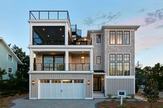 a two story house with multiple balconies on the top floor and second story