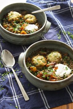 two bowls filled with food sitting on top of a table