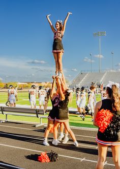 the cheerleaders are doing stunts on the track