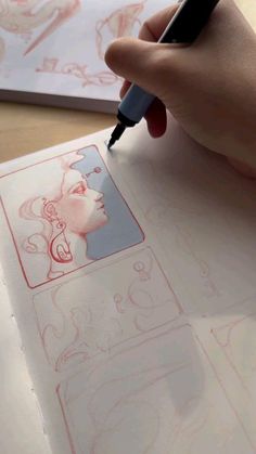 a person is drawing on paper with a pen