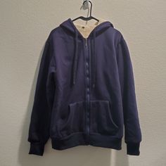 Nwot Navy Blue Zip Up Hoodie With Tan Sherpa Lining. Front Pockets. Drawstring Hood. Size: Xl New Without Tag Approx Measurements Laying Flat: Pit To Pit: 24" Length: 28" Sleeve Length: 26" Sporty Blue Sweater For Winter, Casual Warm Blue Outerwear, Blue Hoodie With Fleece Lining For Winter, Blue Fleece Jacket With Drawstring Hood For Fall, Blue Fleece Hoodie For Winter, Hooded Fleece Sweater With Fleece Lining, Hooded Sweater With Fleece Lining, Navy Hooded Hoodie For Winter, Cozy Blue Outerwear With Ribbed Cuffs