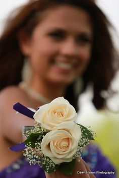 a woman holding a bouquet of white roses