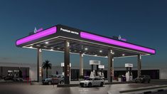 the gas station is lit up with purple lights