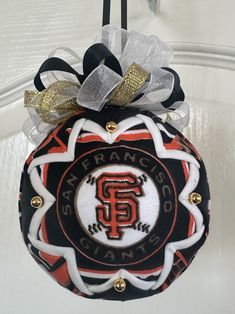 a san francisco giants ornament hanging from a door