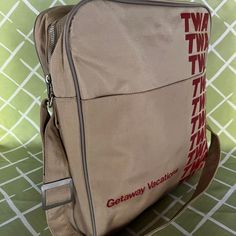 Channel the days when airplane travel was actually glamorous and exciting with this cream-hued vintage TWA messenger-style bag. Dimensions: 12" L x 4" W x 14" H Strap: 11" Vintage Beige Satchel, Vintage Bags With Luggage Sleeve For Overnight Trips, Vintage Satchel Travel Bag, Vintage Rectangular Satchel For Overnight Trips, Vintage Tote Shoulder Bag For Travel, Vintage Beige Shoulder Bag, Beige Shoulder Bag With Luggage Sleeve For Overnight Trips, Vintage Satchel Travel Bag For Weekend Trips, Retro Beige Travel Bag