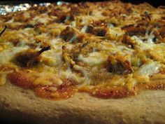 a pizza sitting on top of a pan covered in cheese and toppings with meat