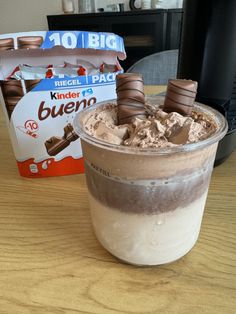 a cup of ice cream and some kind of chocolate thing in it on a table