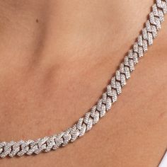 Introducing our 8.5mm Diamond Prong Cuban Necklace, a white gold plated necklace featuring prong links covered in clear stones connecting the full piece. This chain is the perfect size, the middle ground between micro prong and the larger 12mm prong necklace. Paired with the classic 8.5mm Prong Link Bracelet, they make a fabulous fashion set for nights out. This product is guaranteed for life - GLD will repair the item should you experience any defects in craftsmanship or breakage. Specification Elegant Diamond White Cuban Link Chain Necklace, White Diamond Cuban Link Necklace, Luxury White Cuban Link Diamond Necklace, White Gold Cuban Link Necklace With Rhinestones, Elegant Diamond-cut Cuban Link Chain Necklace, Cuban Necklace, Customizable Jewelry, Clear Stone, Colored Gems