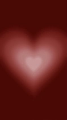 a red heart shaped background with blurry edges and space for text or an image