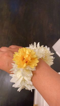 a person's arm with a yellow and white flower on it