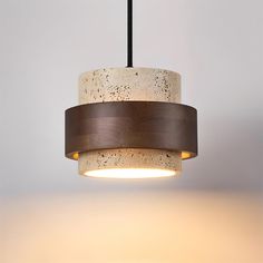 a white and brown light hanging from a ceiling