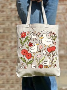 Funny Duck Tote Bag, Cute Duck Tote Bag, Casual Tote Bag, Cute Tote, Animal Lover, Women Shoulder Bag, Gift For Women, Tote Bag Aesthetic 🎉 Welcome to Our Eco-Chic Boutique! 🎉 💐 We're Absolutely Delighted to Have You! 💐 Diving into our boutique feels like uncovering a secret garden of treasures, all thoughtfully selected with you in mind. Our mission is to fill your world with joy and satisfaction, handpicking each piece to ensure your shopping journey with us is nothing short of wonderful. 🌿 A Personalized Shopping Experience Awaits: 🌿 Discover Your Unique Style: Wander through our bespoke collection and find the tote bag that feels like a piece of your soul. Each one tells its own story--are you ready to tell yours? Find Your Perfect Match: Our premium linen tote bags come in a ver Duck With Flower, Canvas Bag Aesthetic, Duck Tote, Aesthetic Bag, Flower Tote Bag, Flower Tote, Aesthetic Bags, Funny Duck, Casual Tote Bag