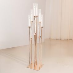 a tall white and gold sculpture sitting on top of a floor