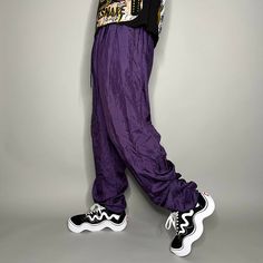 "Vintage Nylon Track Pants Grape Purple Joggers Baggy Fit Elastic Cuffs has Ankle Zippers Lined 90s Skate / Streetwear Great Condition: 9/10 Men's Size: X-Large My Hands in Pockets = It has Pockets No Hands in Pockets = Does Not Have Pockets Drawstring Will be Visible in Forward Pic, if not Visible it Does Not Have a Drawstring About me: I am 6' 0\" for reference I generally wear a Large (32\" inseam) I Model XS to 2XL sweatpants, I find that you can often size up or down with 95% of sweatpants and they fit the same" 90s Style Baggy Parachute Pants For Streetwear, 90s Baggy Parachute Pants For Spring, 90s Baggy Parachute Pants, 90s Style Baggy Parachute Pants, 90s Nylon Parachute Pants For Streetwear, Trendy Nylon Parachute Pants For Streetwear, Streetwear Nylon Bottoms With Elastic Cuffs, 90s Style Parachute Pants For Spring, Nylon Bottoms With Elastic Cuffs For Streetwear