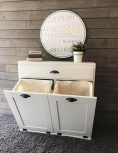 a white cabinet with two drawers and a potted plant sitting on top of it