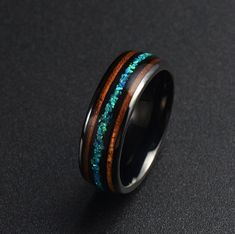 a black ring with blue and brown wood inlays