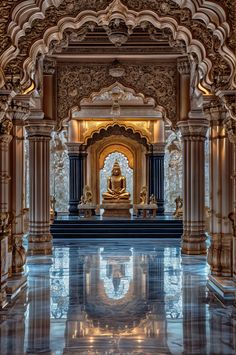 the inside of a building with columns and statues on it's sides, reflecting water in the floor