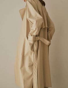 A cool variation of the classic trench, the Lotte Trench features a relaxed, slouchy silhouette with cinchable waist and wrists, rounded shoulders, and deep patch pockets. Also available in dark beige. - Overcut- Pointed collar- Top button closure- Half storm front and back- Removable storm neck piece- Belted waist and cuffs- Angled patch pockets- Back vent- Fully lined- Measurements Length 45.5", Bust 52", Sleeve 31.5"- Outer: 100% Cotton, Lining: 100% Polyester- Dry clean- Imported