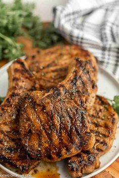 grilled pork chops on a plate with parsley