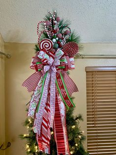 a christmas tree decorated with candy canes and bows