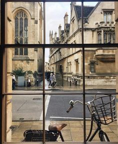 a bicycle is seen through the window of an old building