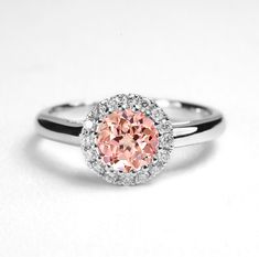 This beautiful Peach Sapphire cluster ring comes with a center round shape 1.0ct lab-grown Peach Sapphire enclosed by 16 round - shape Natural diamonds.  It is a perfect choice for those who are looking for a dainty engagement ring in 9k/14k/18k Yellow, Rose, White Gold or Platinum. It is also a great gift for Christmas, Valentine's day, birthday, anniversary or for celebration for any special occasion. ✯✯ Free UK and USA shipping ✯✯ ✯ ✯ No Custom Charges for USA orders ✯✯  MADE TO ORDER  Please Pink Round Cluster Ring With Halo Setting, Pink Round Cluster Ring With Prong Setting, Promise Ring With Round Birthstone In Halo Setting, Halo Setting Birthstone Ring For Promise, Pink Diamond Ring With Halo Design, Pink Cluster Ring With Halo Setting, Birthstone Ring With Halo Setting For Promise, Pink Round Halo Ring For Wedding, Pink Cluster Ring With Center Stone