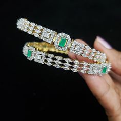 "* Handcrafted Gold Plated 4 Bangle Set. * Bangles with pretty Semi Precious Emerald ,CZ stones * High Quality 22 K Gold Plated- 2 Bangle set * Sizes : 2.2 has a 2.2\" inner circle diameter ; 2.4 ( 2.30\" diameter of the inner circle) ; 2.6 ( 2.46\" diameter of the inner circle); 2.8 (2.54\" diameter of the inner circle) 2.10 (2.60\"diameter of the inner circle) * Sold as a set of 2 Gorgeous gold-plated bangle/ bracelet best exemplifies the careful craftsmanship done on it -- a specialty at Nema Wedding Jewelry Bangle With Jewels, Stone Bangle Jewelry For Parties, Stone Bangle Bracelets For Wedding, Green Stone Set Bracelets For Weddings, Party Bangle Jewelry With Stones, Party Bangle With Stones, Green Wedding Bracelets With Stone Setting, Cubic Zirconia Bangle With Stone Work For Wedding, Sparkling Stones Bangle For Anniversary