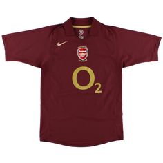 a maroon shirt with gold lettering on the chest and two yellow letters that say o2