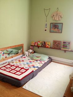 a child's bedroom with green walls and wooden flooring, including a bed