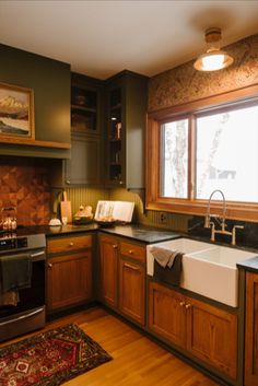 a kitchen with wooden cabinets and black counter tops, white sink and dishwasher