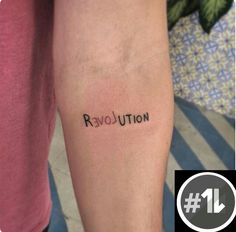 a person with a tattoo on their arm that says revolution above the word revolution in cursive font