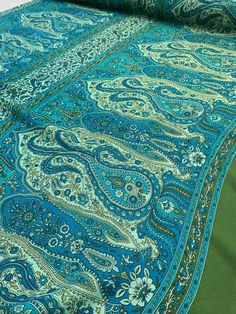 the blue and green paisley print is on display