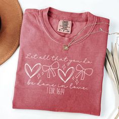 Are you looking for the perfect religious Valentine's Day shirt ?  This trendy coquette bow Valentines Day t-shirt makes the perfect gift for any religious Mom, daughter, or wife. Pick up this doodle heart Valentines day shirt today for yourself or as a gift! This shirt is Comfort Colors unisex brand. These shirts can be sized up for a cute mom shirt with a trendy oversized look. ~Shirt Info~ -Comfort Colors brand -100% ring-spun cotton -Medium fabric (6.1 oz/yd² (206.8 g/m -Unisex Size/Relaxed fit -Sewn-in twill label ~Size guide~ This unisex fit t-shirt is intended to be loose/oversized. It is super cute to be worn with rolled-up sleeves and a side or front knot. If you prefer something more fitted, we recommend ordering a size down. For an oversized super trendy look, up a size or 2 fro Valentine Shirt Ideas For Women, Diy Valentine Shirt, Christian Valentines Shirts, Valentine’s Day Shirt Ideas, Valentine’s Day Shirts, Valentines Day Tshirt Ideas, Valentines Day Shirt Ideas, Valentines Shirt Ideas, Valentine Shirt Ideas