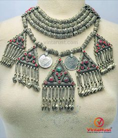 *This Afghani Kuchi multilayer beaded necklace is a classy yet subtle. This multilayer Afghani choker necklace has antique coins and five vintage-inspired pendants which are beautified by red glass stones. This tribal choker necklace is everything you need in your life. *Made up of the best quality of metal alloy this tribal necklace is fashionable, bold, and vibrant. It combines both traditional and modern elements. This boho tribal multilayer choker necklace has a black thread for tying a knot Red Bohemian Choker Necklace, Red Necklaces With Silver Beads For Festival, Red Necklace With Silver Beads For Festival, Bohemian Festival Layered Choker Necklace, Bohemian Silver Choker With Round Beads, Silver Bohemian Beaded Choker, Handmade Bohemian Metal Layered Necklace, Handmade Metal Bohemian Layered Necklace, Red Multi-strand Jewelry For Festivals