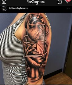 a woman's arm with a clock and heart tattoo on the left side of her arm