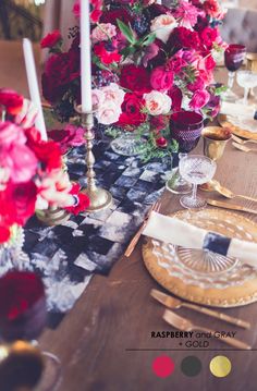 the table is set with flowers and candles